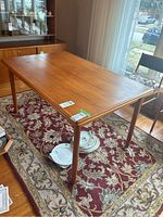 Perspective view of teak dining table top and legs in room setting