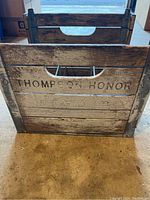 Front view of vintage wooden dairy box with visible brand and series line text.