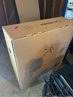 Cardboard box containing Kingdom Cot 3 portable cot, showing schematic diagram and brand name on the box.