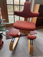 Front view of entire chair showing seat, backrest and knee rests