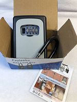 Key lock box inside open cardboard packaging with instruction sheet visible.
