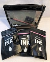 Photo showing three black pouches of ink labeled 'Shading Ink' and 'Freehand Ink', inside clear zippered pouch.