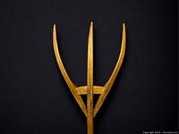 Close-up of the hay fork prongs showing three wooden tines connected by two braces secured with hand forged nails.