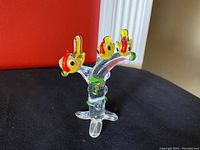 Front and side view of vintage yellow sparrow hen and chicks art glass sculpture on clear glass tree base.