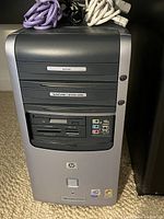 Front view of HP Pavilion a250e tower showing DVD ROM, DVD writer/CD writer combo, multi-format card readers, and USB/audio ports