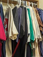 Hanging rack of assorted graphic and solid-color tee-shirts and sweatshirts