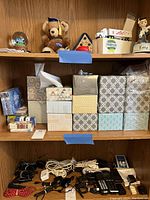 Shelf with multiple decorative tissue boxes lined up, some with tissues partially visible.