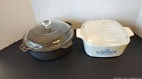 Photo of Wagner cast iron casserole and CorningWare casserole side by side showing size and style