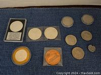 Overview of all coins in lot on blue textured surface