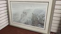Full view of framed limited edition print depicting white wolves on snowy cliff