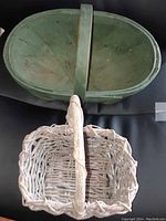 Top view showing both baskets, green apple basket is larger and painted, twig basket smaller and woven light wood.