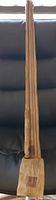 Full length view of the vintage bamboo fishing rod showing its straight, slender natural bamboo construction.