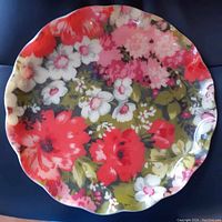 Top view of the large Fab Tray showing a vibrant floral fabric pattern sealed under clear polyester with scalloped edges.