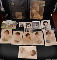 General overview of all items in the lot including the litho prints, 3D card, celebrity studio prints, and the photo of a young lady playing mandolin.