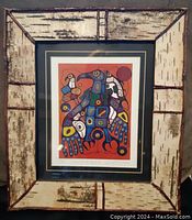 Front of framed print showing birch bark-style frame with double black and gold mat around colorful Thunderbird print.