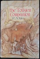 Front cover of 'The Tolkien Companion' showing title, author, and Tolkien-style fantasy art of two figures and large tree.