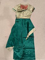 Green and gold women's dress laid flat showing full length and asymmetric hem