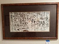 Framed artwork view showing full print with frame hung on wall