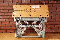 Front view of foldable work bench showing wooden clamping surface and Black & Decker logo