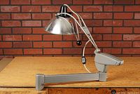 Side view of Wilmot Castle articulated lamp mounted on a table, showing long extendable arm and large metal shade