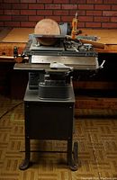 Front view showing table saw bed, disc sander on top, fence and base