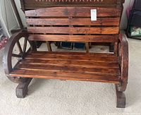Front view of the wooden bench showing slatted seat and backrest.