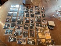 Wide view of dozens of Beatles cards laid out on wood table