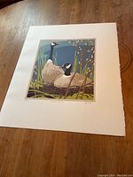 Full view of lithograph sheet with margins showing two geese nest