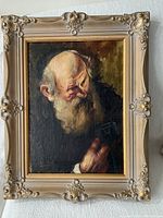 Full view of framed oil painting showing the elderly rabbi in dark clothing with ornate frame.