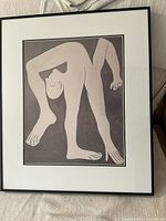 Front view of the framed Picasso print featuring the stylized human figure artwork.