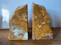 Front view of the two stone bookends side by side showing polished natural stone patterns.