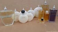 Photo showing 12 capless perfume bottles consisting of Pure Alfredo Sung, AV, Sung EDT, and Sung Homme perfumes.