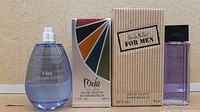 Photo showing all four colognes together: Alfred Sung Hei bottle, boxed Bob Mackie, boxed Nicole Miller, and Sung Homme bottle.