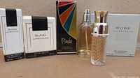 Several boxed perfumes with three bottles in front showing sizes, brands Alfred Sung, Rob Mackie, PURE Alfred Sung bottles.