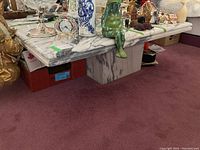 Full view of marble coffee table showing square top with gray veining and solid pedestal base.
