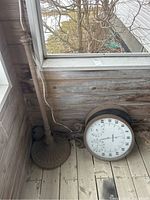 Photo showing thermometer and base positioned near a window on wooden floor, illustrating overall size and assembly state.