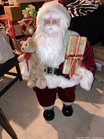 Front view of the 36 inch Santa figurine showing details of face, beard, glasses, bear, and gift.