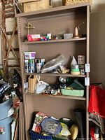 Full view of the shelving unit assembled with items on shelves, showing the structure and color.