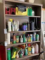 Full front view of five-tier metal shelving unit with various items on shelves to indicate usage and size.