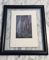 Full view of framed print showing black floating frame, white mat and artwork of forest scene.