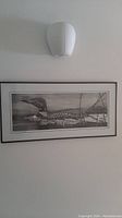 Full view of the framed print showing a loon on the water in black and white.