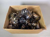 Box filled with numerous silver plate goblets of various sizes and shapes, showing tarnish and used condition.