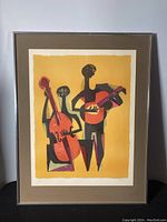 Front view of the framed print showing the full artwork with two abstract musicians playing cello and guitar.