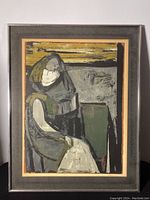 Framed abstract print featuring a seated figure in muted tones with yellow accent, showing overall front view.