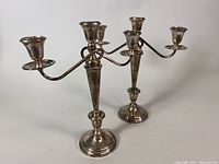 Both assembled candelabras displayed side by side.