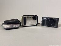 Two digital cameras and a soft carrying case displayed together