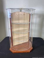 Front view of the vintage Citizen display stand showing three clear shelves and the Citizen logo on the back panel