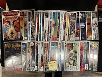 Photo showing a collection of high grade comics including Spider-Man, Daredevil, and others, all bagged and boarded.