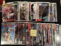 Photo showing a collection of approximately 50 comic books, individually bagged and boarded. Titles visible include New Warriors, Nova, Micronauts, X-Men, Batman, among others.