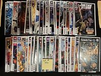 Two rows of comic books displayed side by side, all in plastic bags with backboards inside, showing front covers.